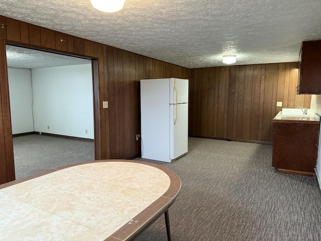 kitchen featuring tile counters, carpet floors, a textured ceiling, and white refrigerator