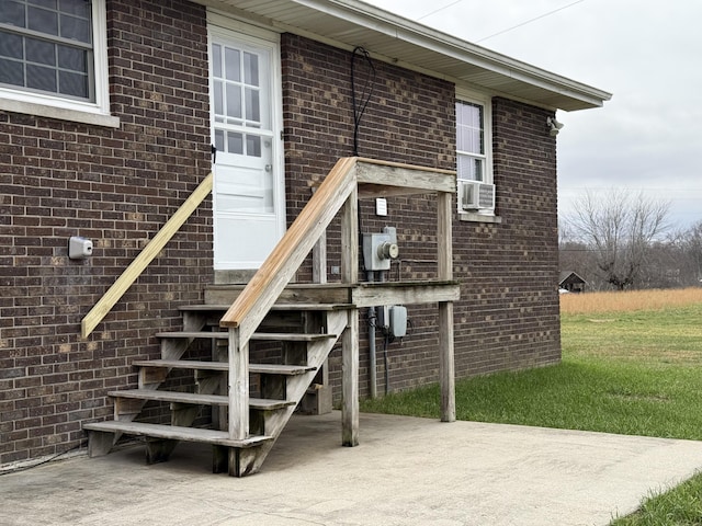 entrance to property featuring cooling unit and a patio area