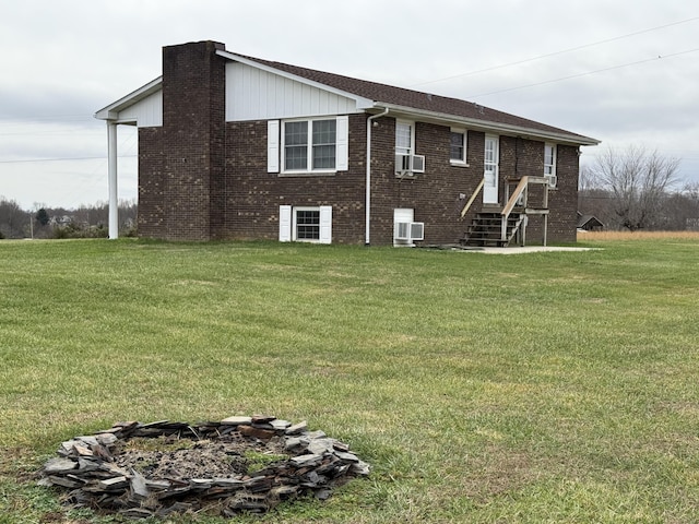 back of house featuring a yard and cooling unit