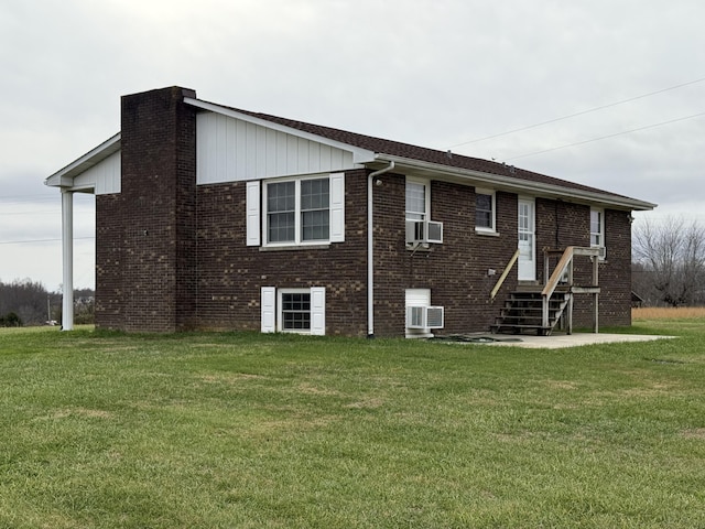 back of house with a lawn and cooling unit