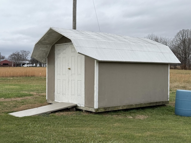 view of outbuilding featuring a lawn