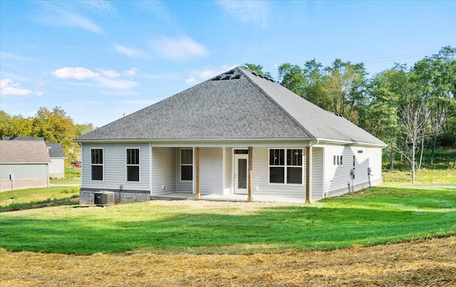 back of house featuring a yard and central AC