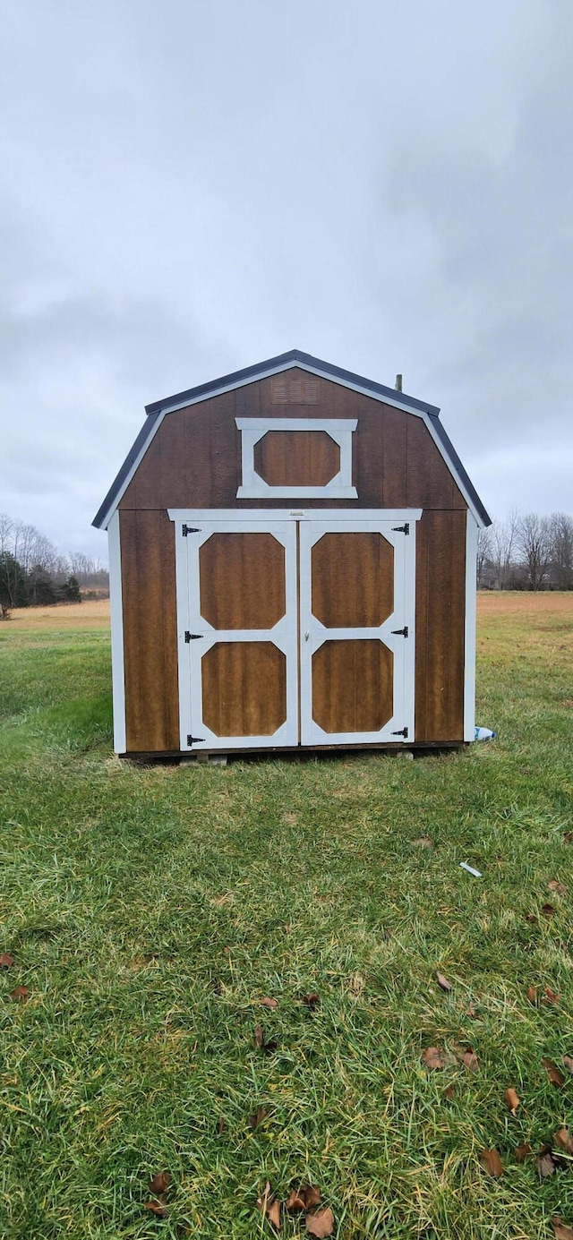 view of outbuilding with a lawn