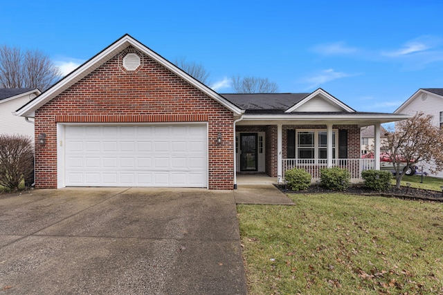 ranch-style house with covered porch, a garage, and a front yard