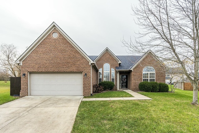 view of front of property with a front yard and a garage