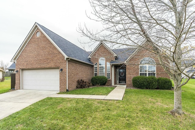 view of front of home with a front lawn and a garage