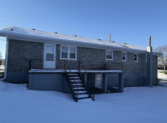 view of snow covered rear of property