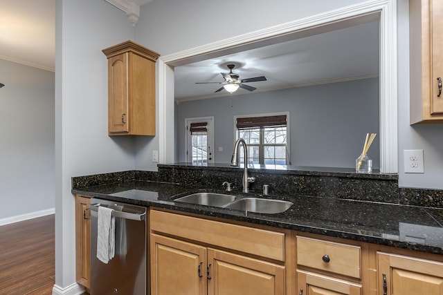 kitchen featuring dishwasher, a sink, ornamental molding, and dark stone counters