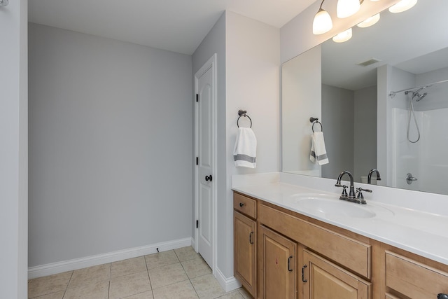 full bath with vanity, visible vents, walk in shower, tile patterned floors, and baseboards