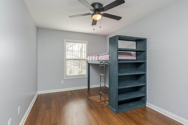 unfurnished bedroom with visible vents, baseboards, and wood finished floors