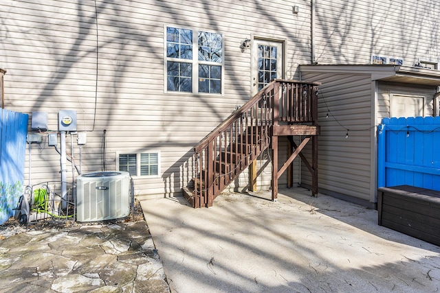 property entrance featuring central AC unit and a patio