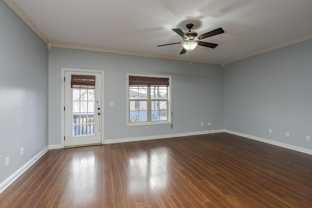 spare room with dark wood-style floors, baseboards, crown molding, and ceiling fan