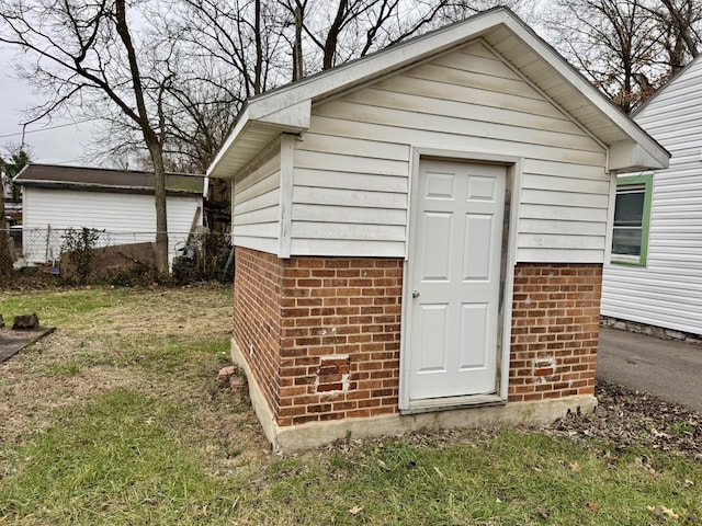 view of outbuilding featuring a lawn