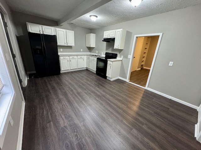 kitchen with a textured ceiling, dark hardwood / wood-style floors, white cabinetry, and black appliances