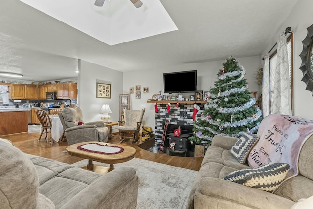 living room featuring ceiling fan and light wood-type flooring