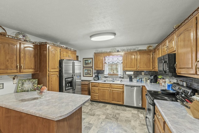 kitchen featuring appliances with stainless steel finishes, a textured ceiling, tasteful backsplash, and sink