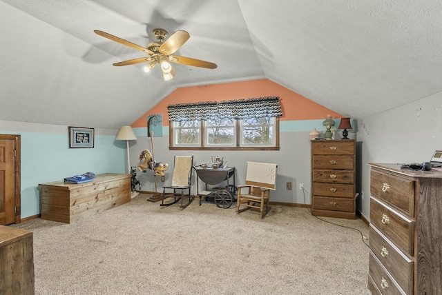 interior space with a textured ceiling, light colored carpet, ceiling fan, and lofted ceiling