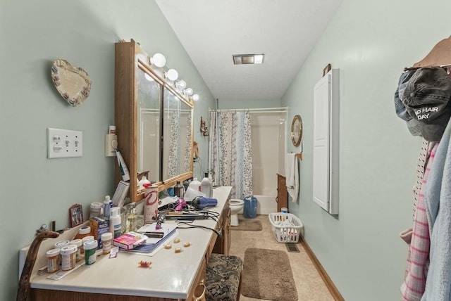 full bathroom featuring vanity, shower / bath combination with curtain, and toilet