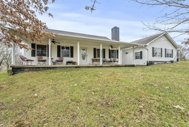 back of property featuring a porch and a yard