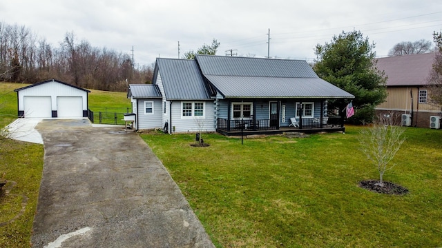 view of front of property with a garage, covered porch, an outbuilding, and a front yard