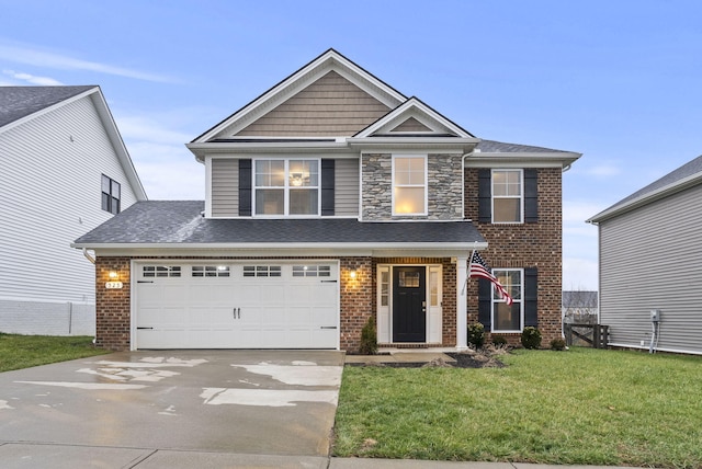 view of front of home with a garage and a front lawn