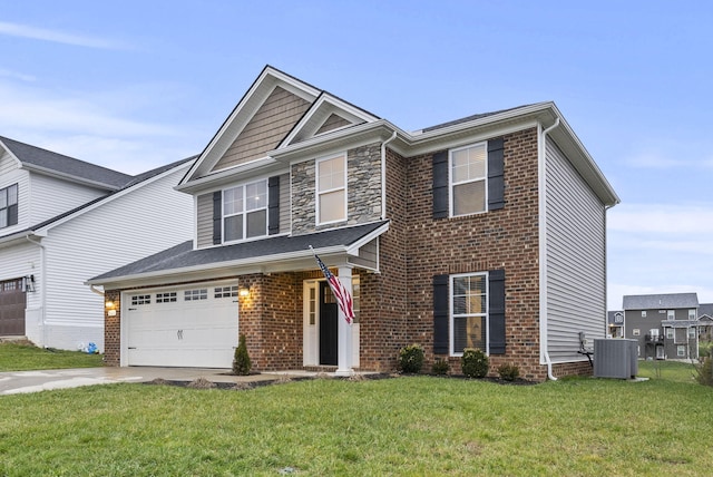 view of front of house with central AC, a front lawn, and a garage