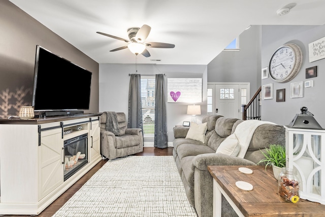 living room featuring dark hardwood / wood-style flooring and ceiling fan