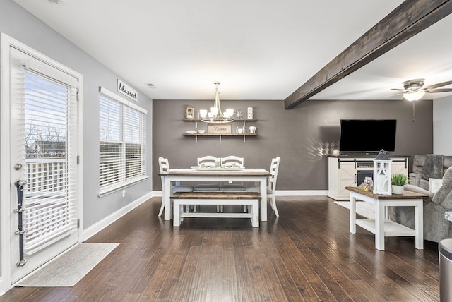 dining room featuring ceiling fan with notable chandelier, beam ceiling, and dark wood-type flooring