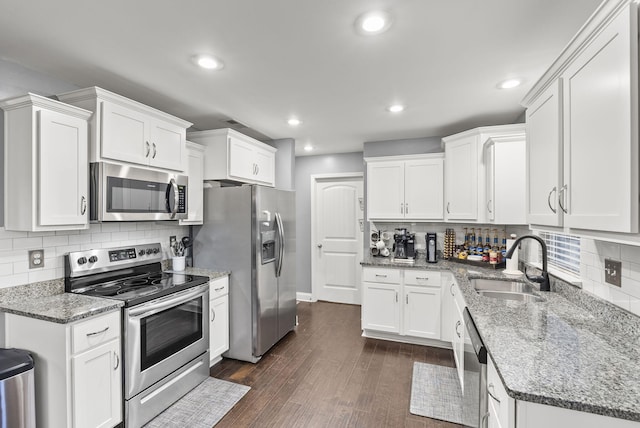 kitchen with white cabinets, dark hardwood / wood-style flooring, stainless steel appliances, and sink