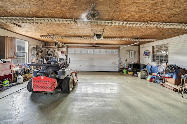 garage with a garage door opener and electric panel