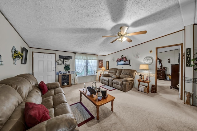 carpeted living room featuring ceiling fan, ornamental molding, and a textured ceiling