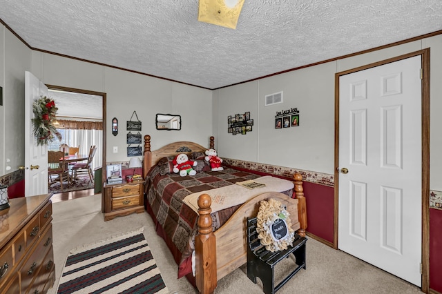 bedroom featuring crown molding, light colored carpet, and a textured ceiling