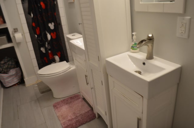 bathroom with vanity, toilet, and walk in shower