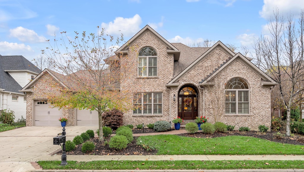 front facade featuring a front lawn and a garage