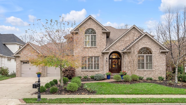 front facade featuring a front lawn and a garage