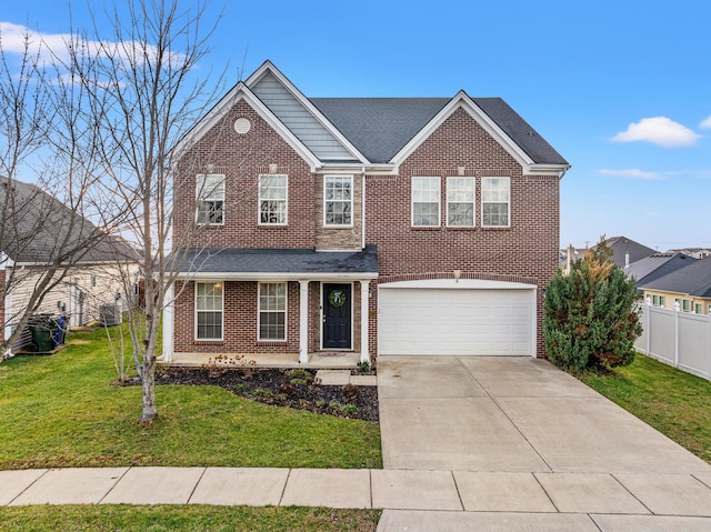 view of property featuring a front lawn and a garage