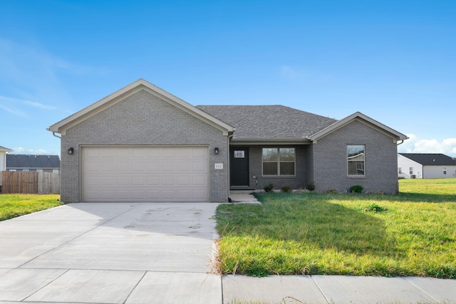 ranch-style house featuring a front yard and a garage