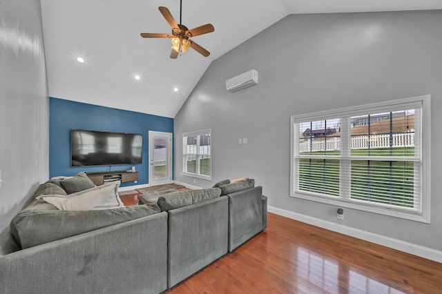 living room featuring hardwood / wood-style floors, high vaulted ceiling, ceiling fan, and a wall unit AC