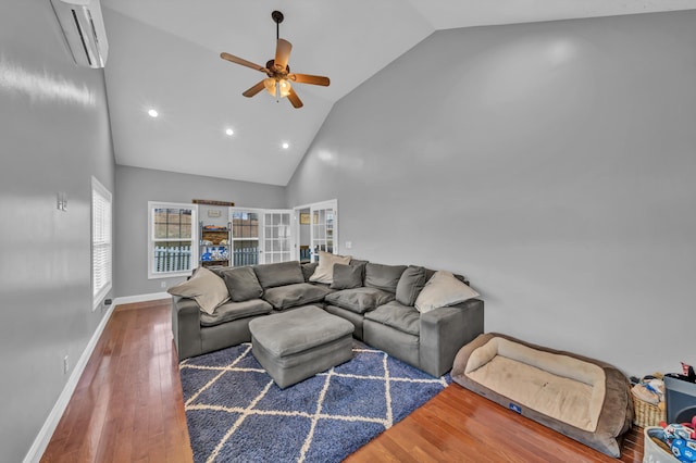 living room with ceiling fan, dark hardwood / wood-style flooring, high vaulted ceiling, and a wall mounted air conditioner