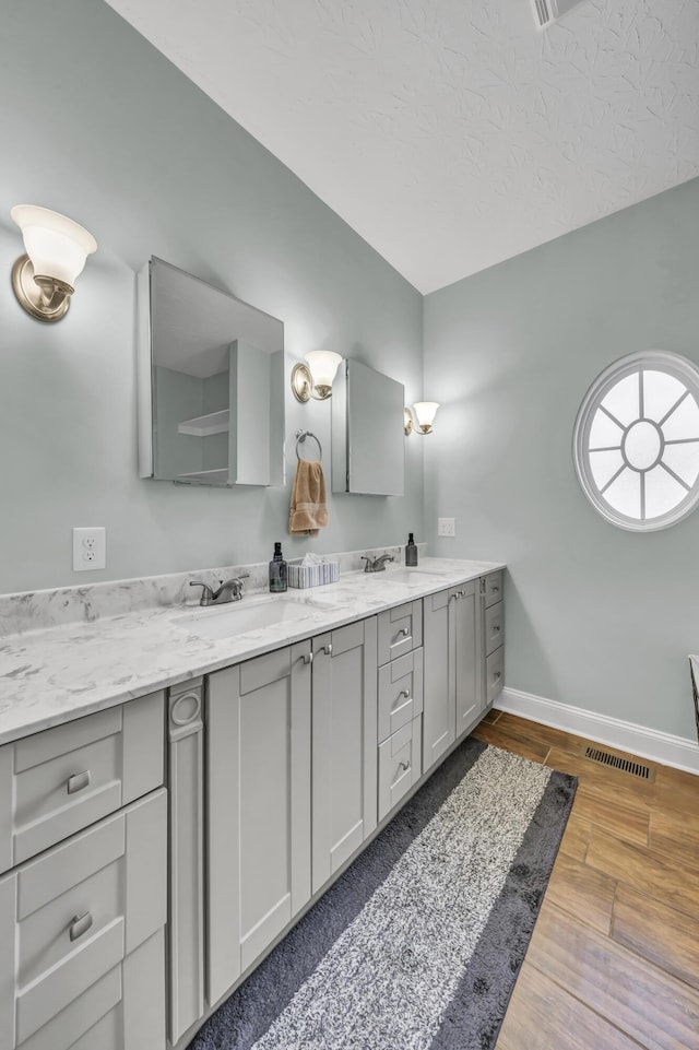 bathroom featuring vanity and a textured ceiling