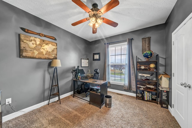 carpeted office space with ceiling fan and a textured ceiling