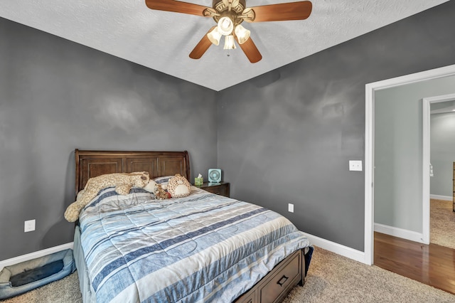 carpeted bedroom with a textured ceiling and ceiling fan