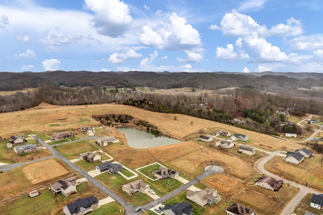 drone / aerial view with a water and mountain view