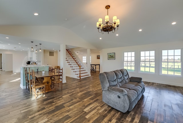 living room with hardwood / wood-style flooring, vaulted ceiling, and a chandelier