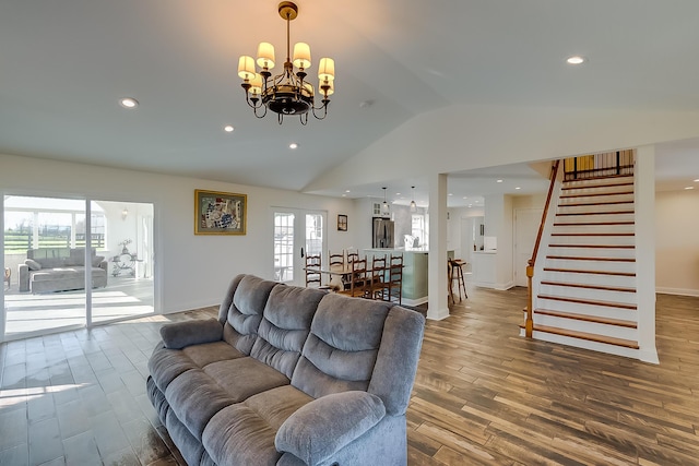 living room featuring a notable chandelier and lofted ceiling