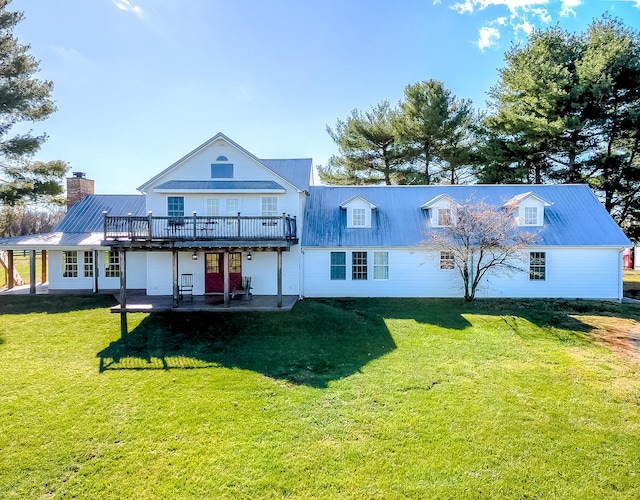 back of house with a lawn, a patio, and a wooden deck