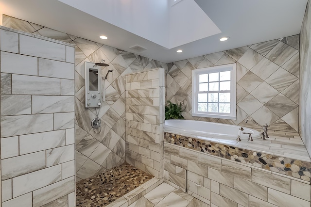 bathroom with independent shower and bath and tile walls