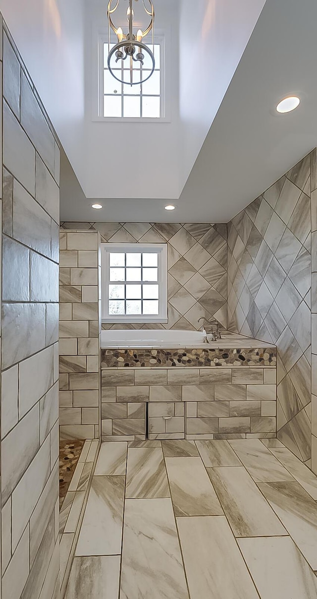 interior space featuring a notable chandelier and independent shower and bath