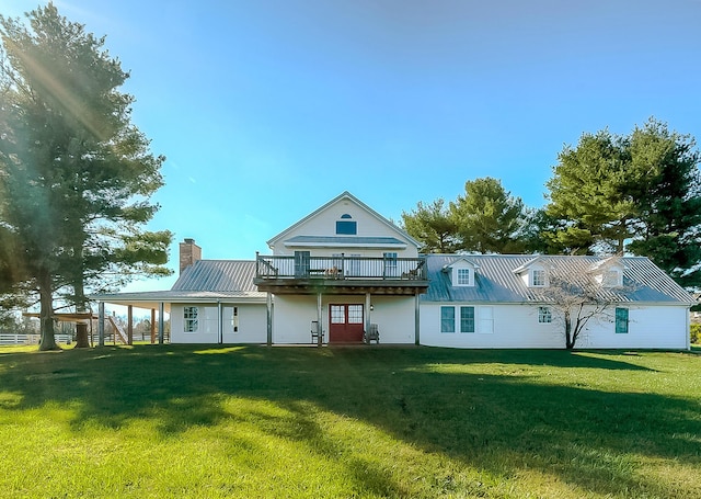 rear view of house with a yard and a deck