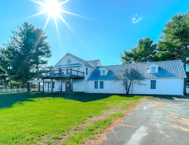 view of front of home featuring a front lawn and a deck